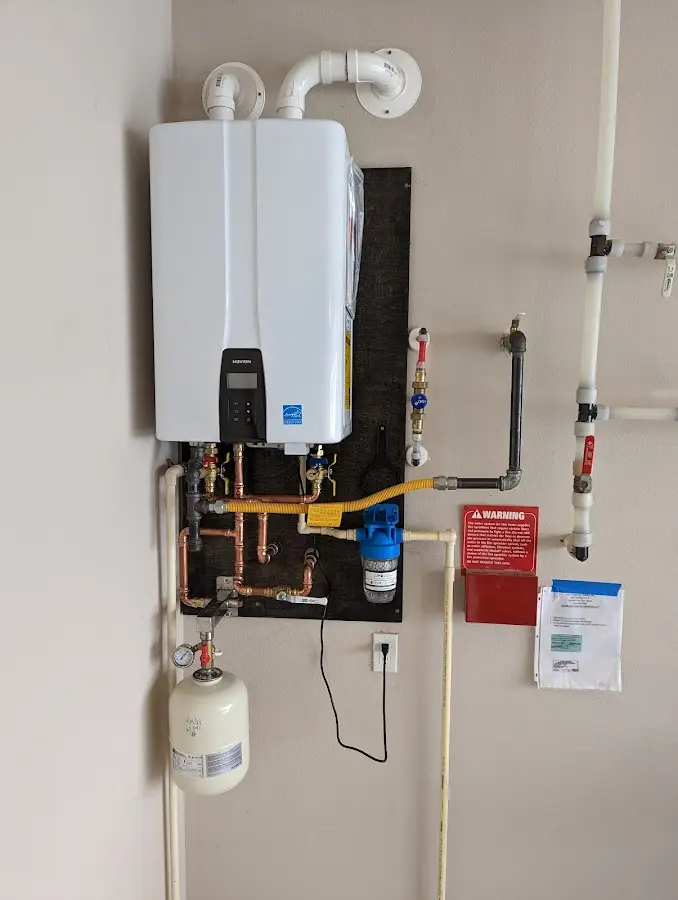 Professional plumber installing copper piping in a Blythewood home